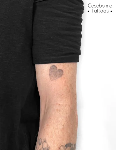 Petit tatouage d'un cœur noir, sur le poignet, à Toulouse