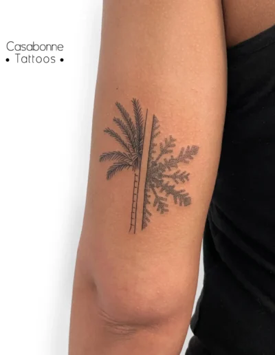 Tatouage dotwork d'un palmier et d'un flocon de neige en miroir, sur le bras, à Toulouse